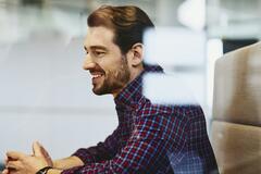 Man with beard in an office. 